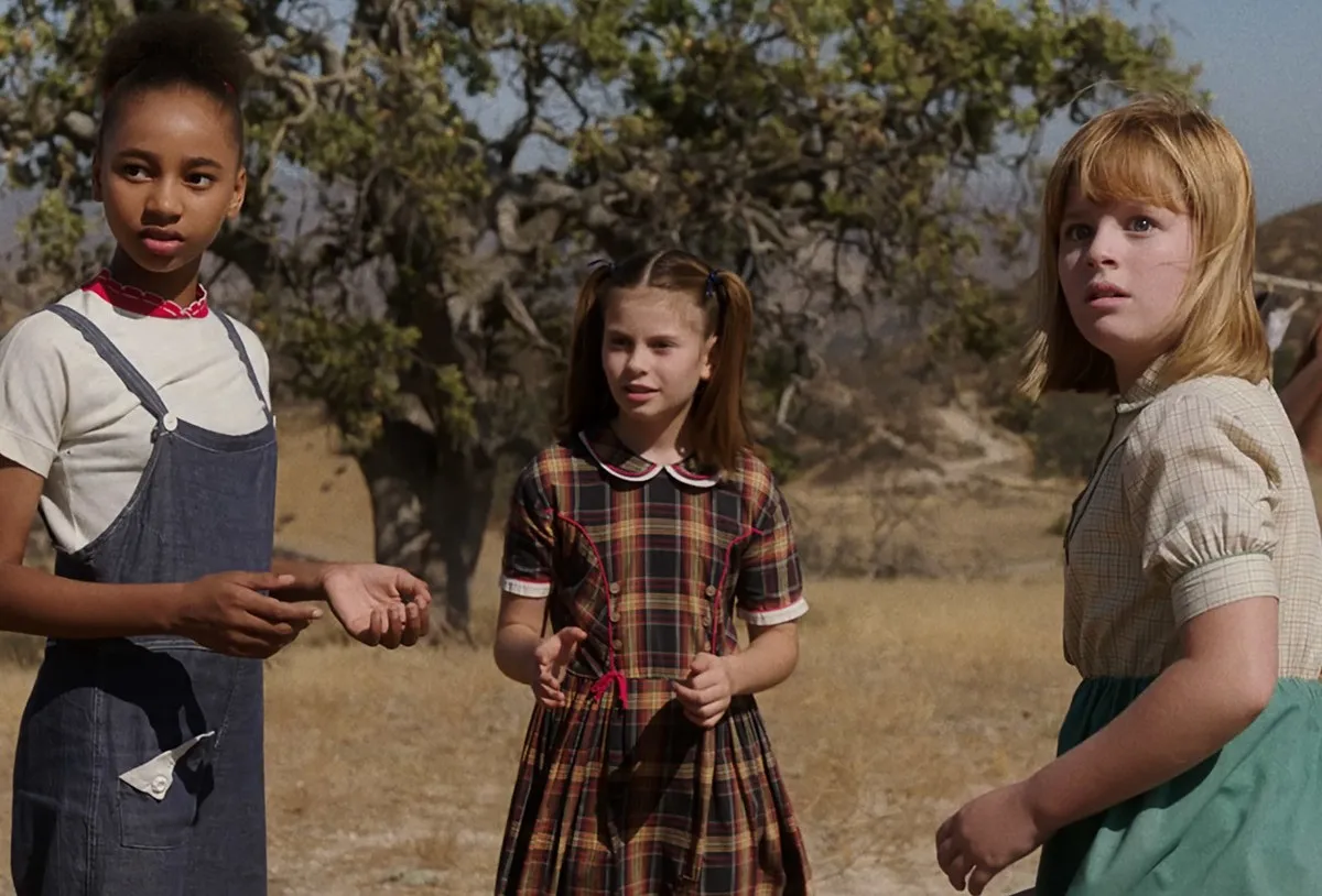Three children in a field staring off into the distance in "Annabelle: Creation"