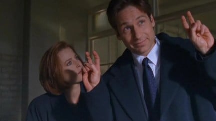 Mulder and Scully with playful looks in 