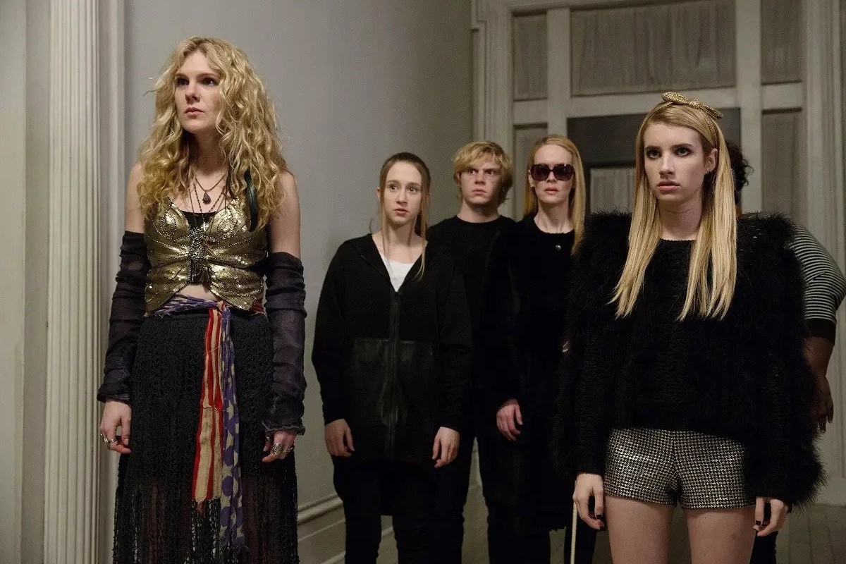 A group of witches each wearing all black give death stares into the distance in "American Horror Story: Coven"