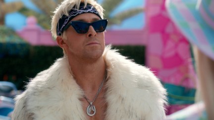 Ryan Gosling as Ken in the movie Barbie, wearing a white fur coat and sunglasses, mugging.