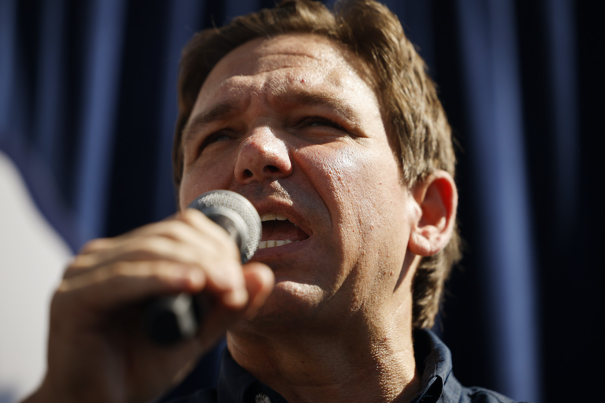 A closeup of Ron DeSantis talking into a microphone.