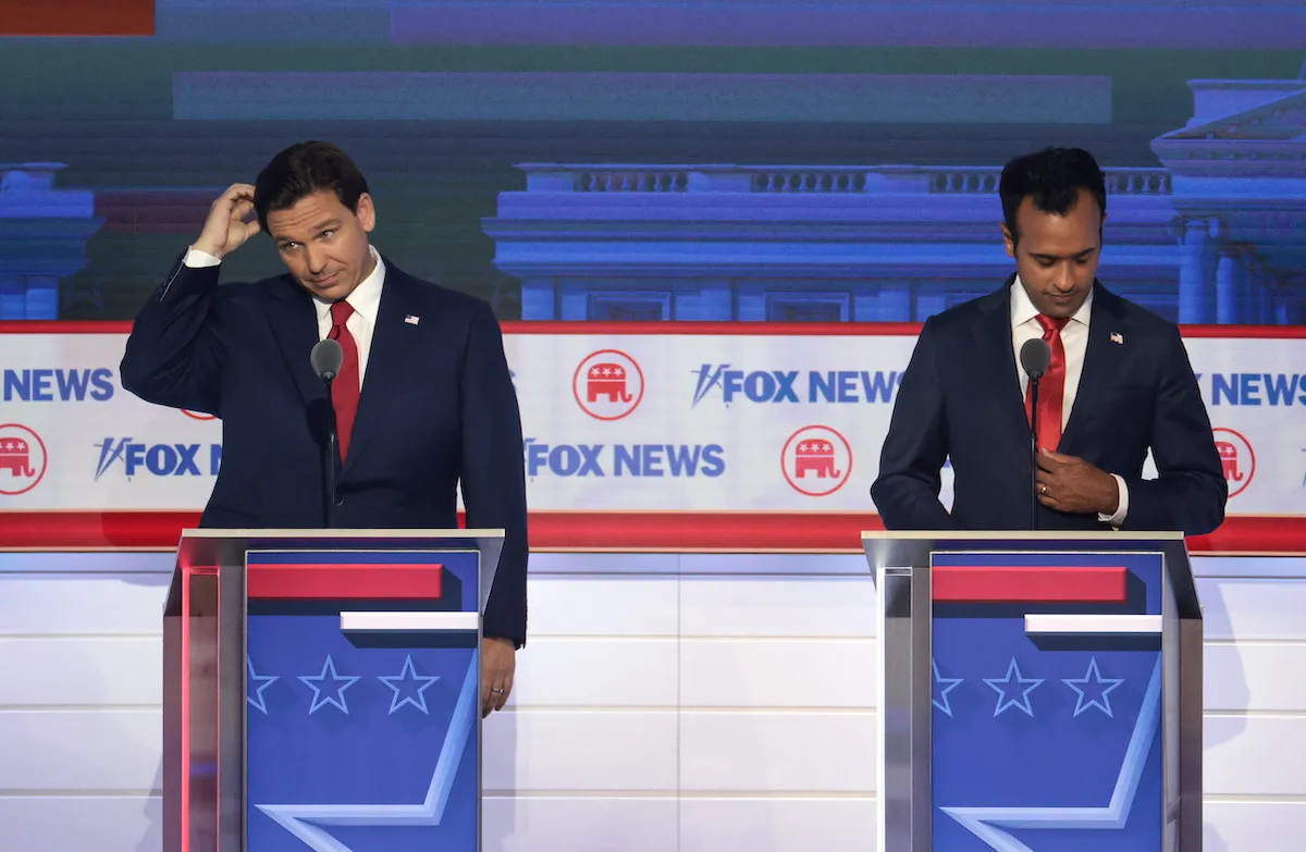 Ron DeSantis and Vivek Ramaswamy look uncomfortable at their podiums during the Republican debate.