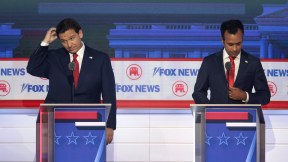 Ron DeSantis and Vivek Ramaswamy look uncomfortable at their podiums during the Republican debate.