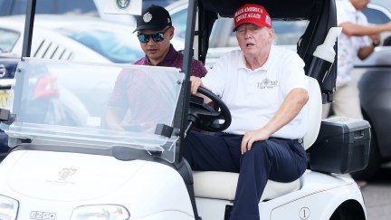 Donald Trump drives a golf cart.