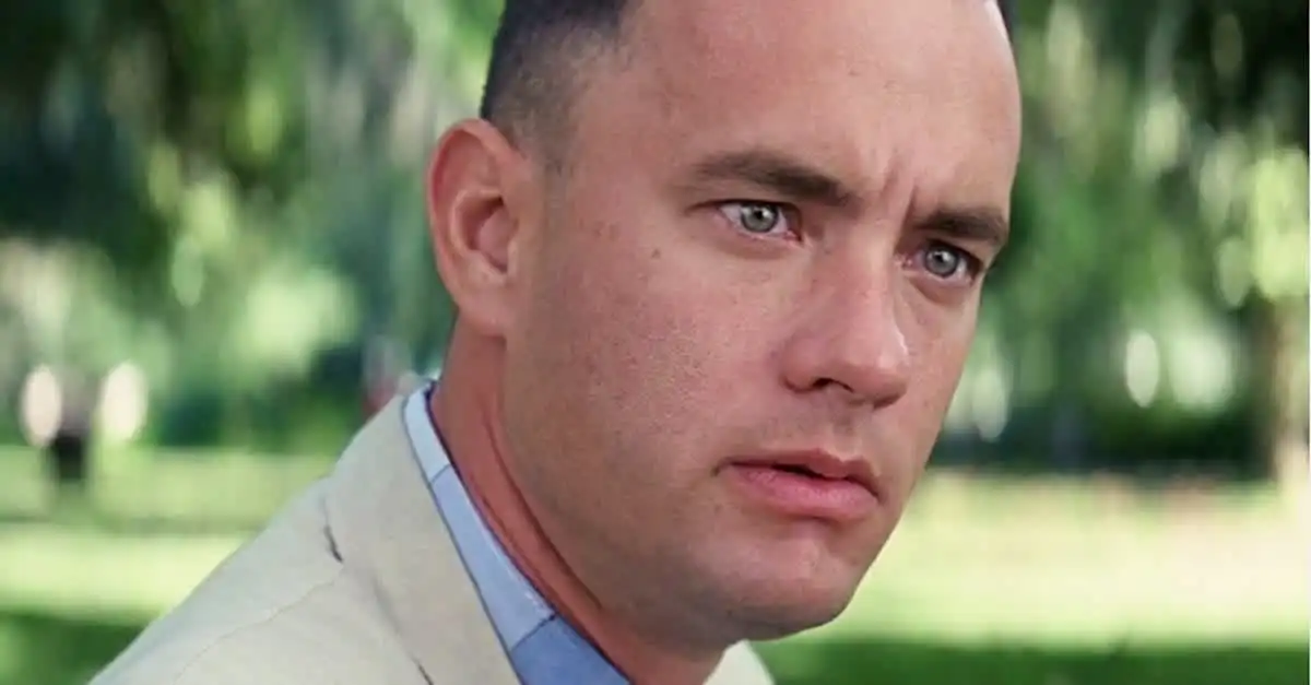 Tom Hanks in "Forrest Gump" sitting on a bench looking into the camera with a confused look on his face.