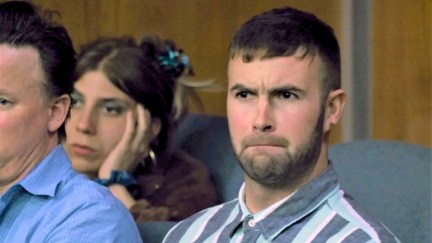 Ronald from Freevee's Jury Duty show making a displeased face as he listens to testimony in the jury box.