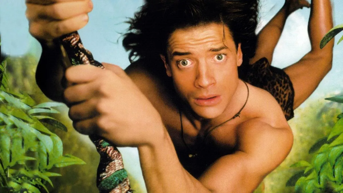 Brendan Fraser in "George of the Jungle" swinging on a vine looking confusingly into the camera.
