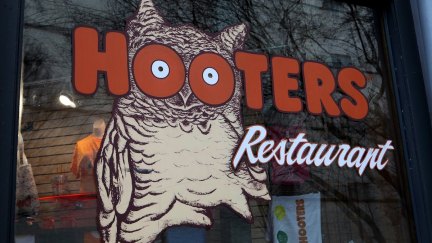 The sign outside a Hooters restaurant featuring its logo of an owl.
