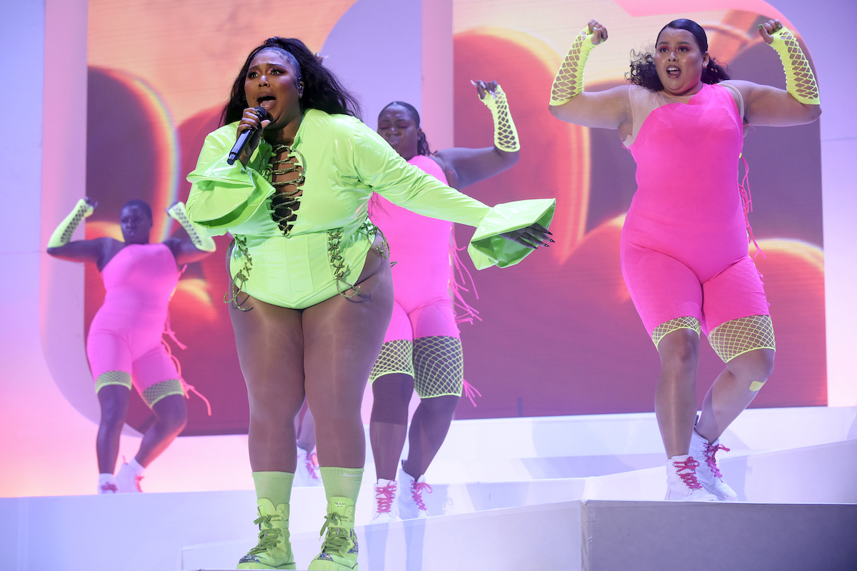 Lizzo performs in front of backup dancers.