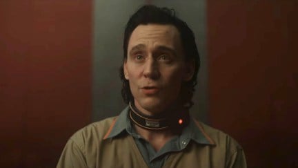 Loki looks worried as he speaks, wearing his TVA prisoner's jumpsuit and a time collar in the Loki season 2 trailer.