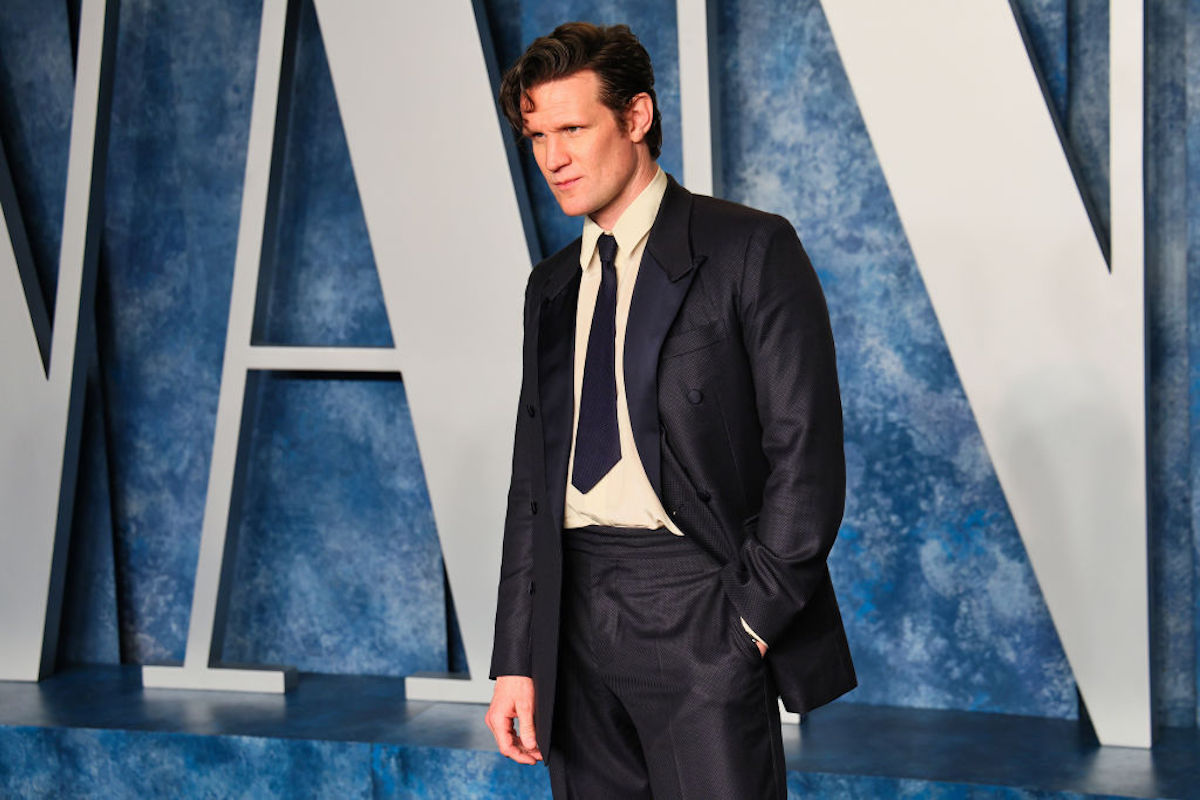 Matt Smith poses on a red carpet with the Vanity Fair logo behind him.