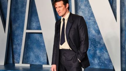 Matt Smith poses on a red carpet with the Vanity Fair logo behind him.