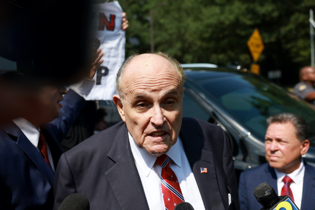 Rudy Giuliani speaks to reporters.
