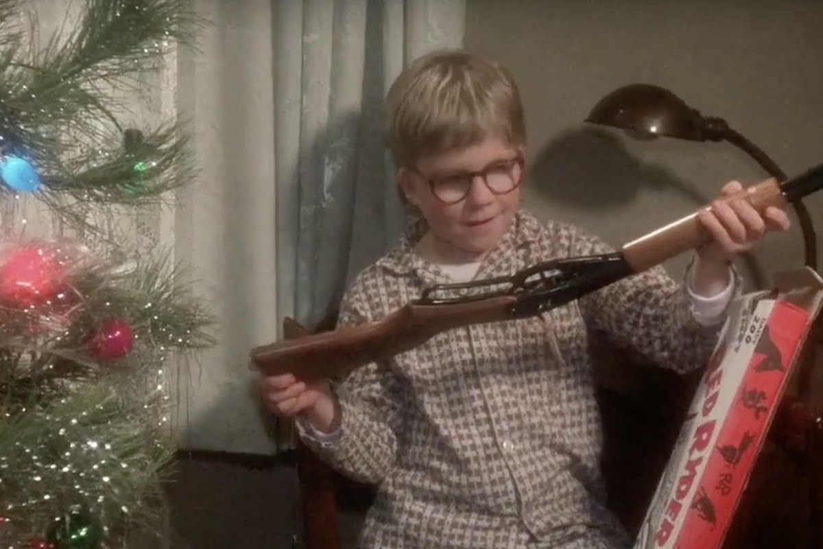 In a scene from A Christmas Story, a young boy (Raphie) marvels at a small rifle.