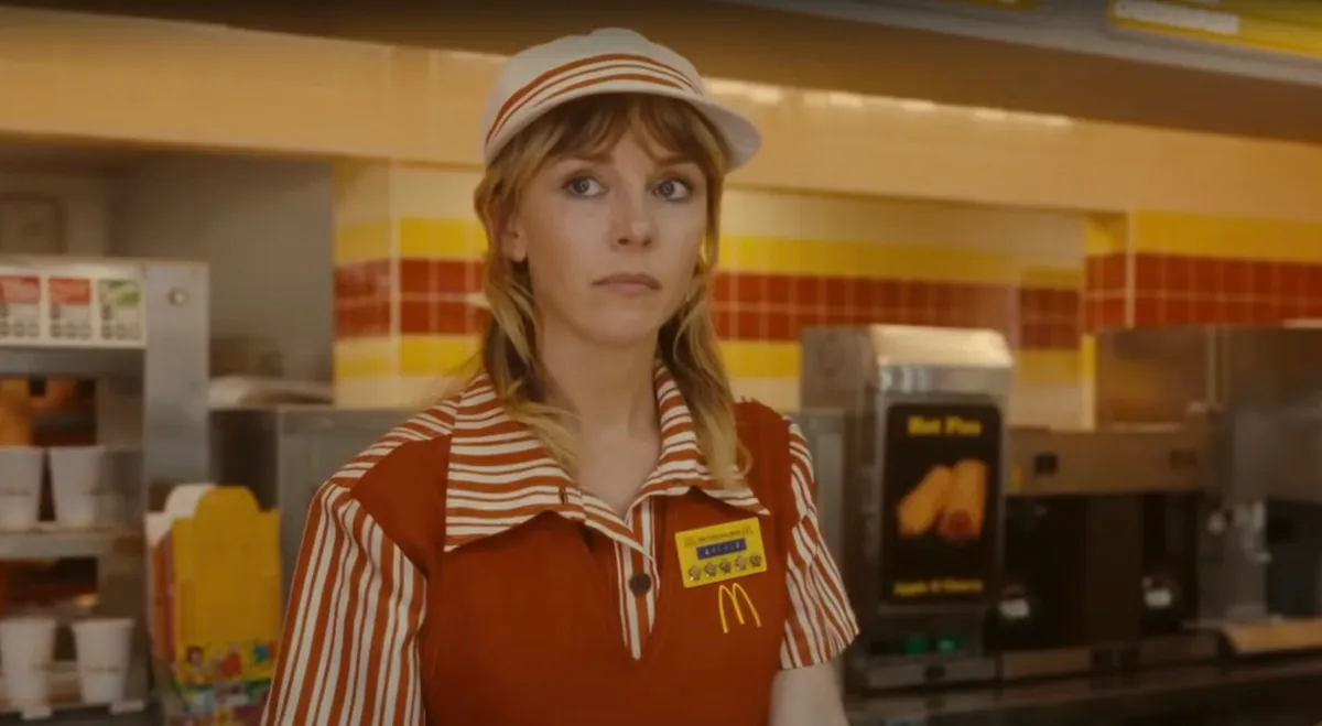 Sylvie (Sophia Di Martino) stands behind a counter, wearing a McDonald's uniform in 'Loki' season 2