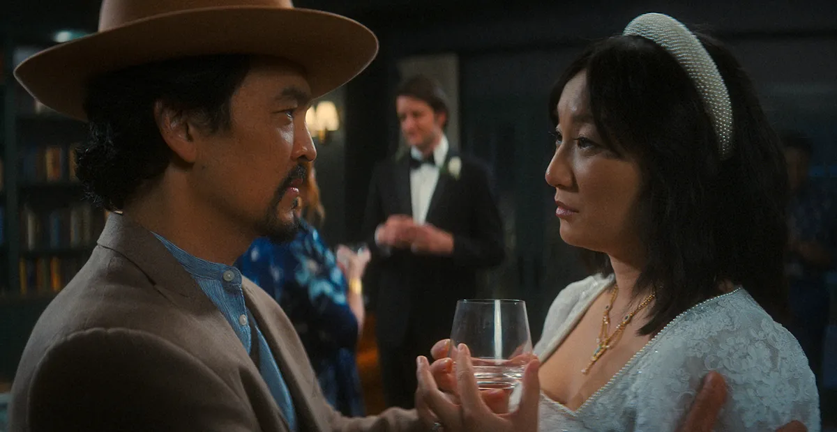 John cho and Poppy Liu having and intense conversation in "The Afterparty"