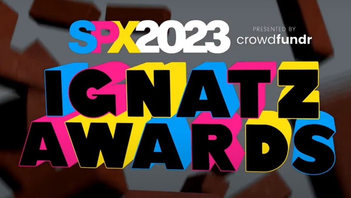 A screencap from the 2023 Ignatz Awards livestream, taken just before the awards began. Behind a falling brick background, "IGNATZ AWARDS" is written in blue, pink and yellow text. Above this in smaller letters, "SPX 2023, presented by Crowdfundr" is written.