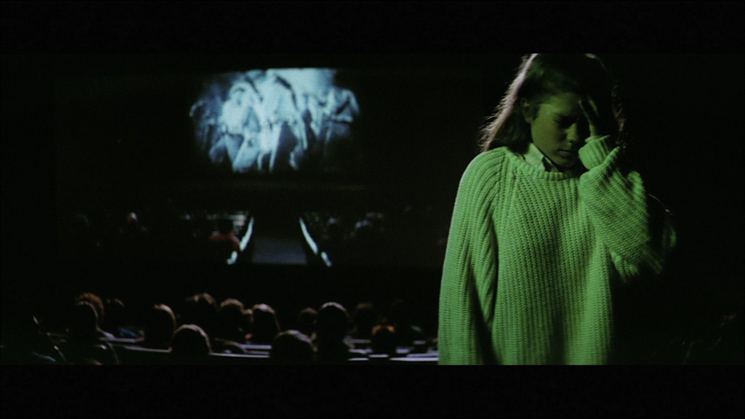 Teenage Patty (Talia Paul) turns away in discomfort from a disturbing theatrical movie screening in ‘Anguish.’