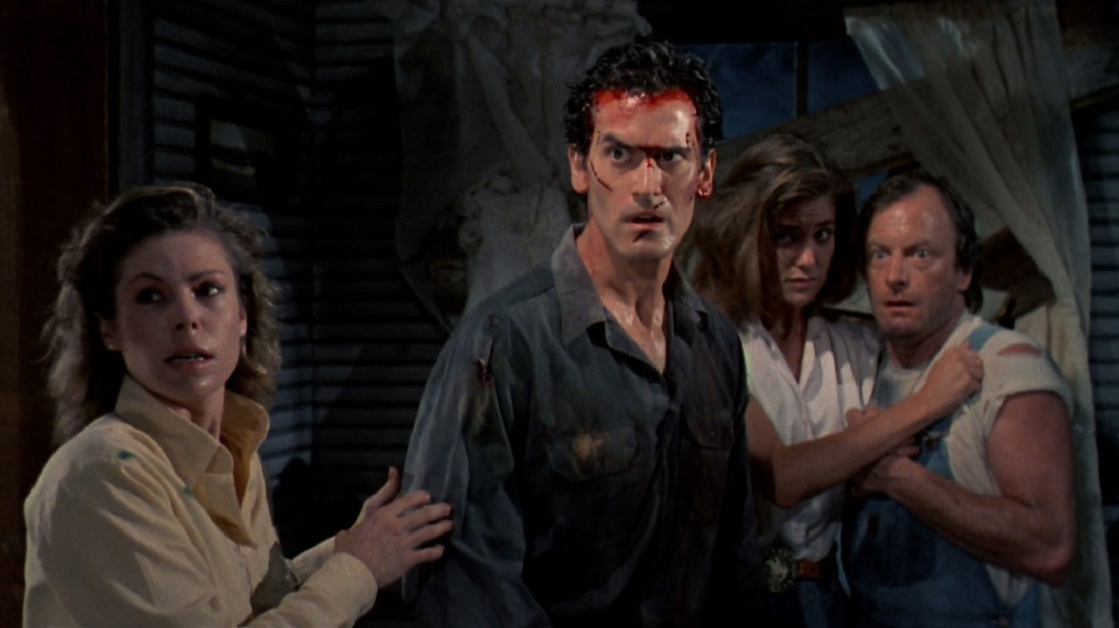 Annie (Sarah Berry), Ash (Bruce Campbell), Jake (Dan Hicks), and Bobby Joe (Kassie Wesley) stare, astonished, into pure evil in ‘Evil Dead II.’ 