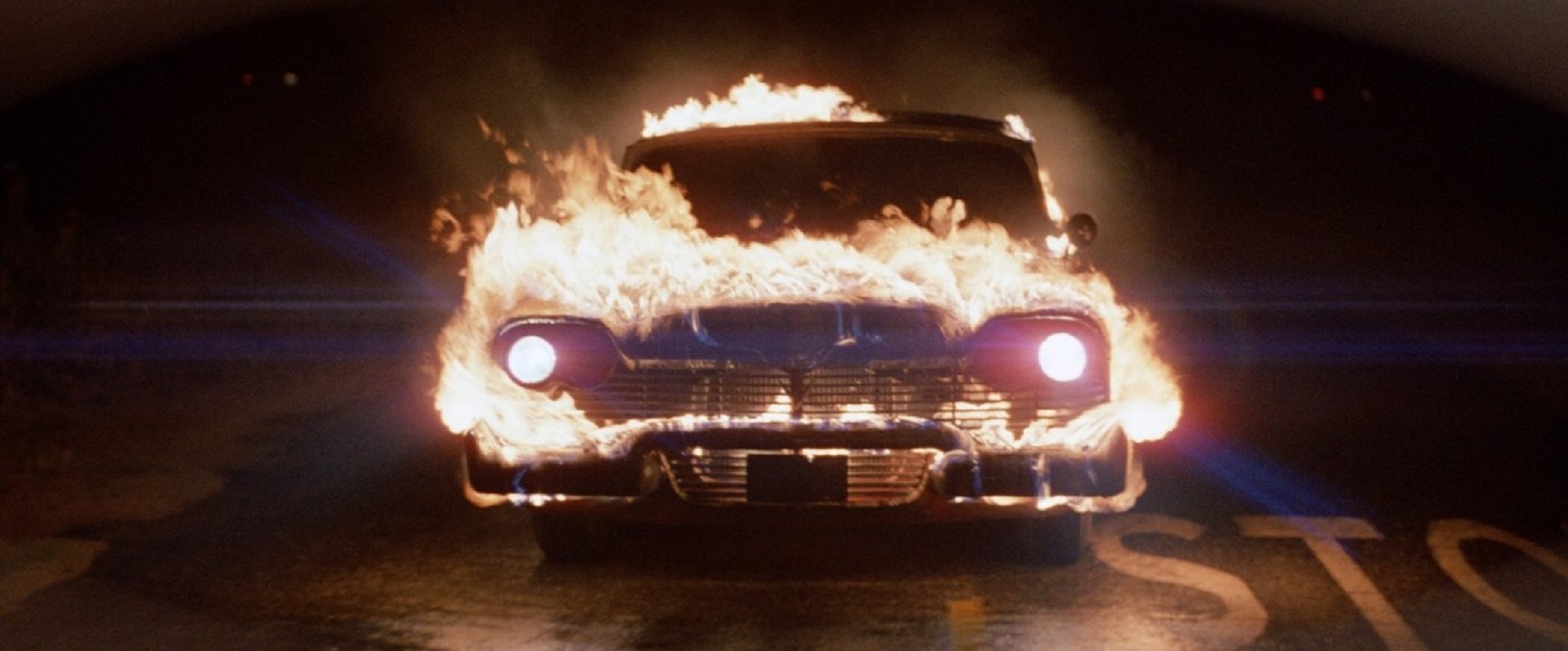 A driver-less red and white 1958 Plymouth Fury engulfed in flames stalks the streets in search of vengeance in ‘Christine.’ 