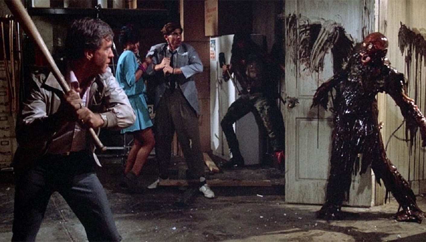  Armed with a wooden baseball bat, Burt Wilson (Clu Gulager) and a trio of terrified teens face off against a viscous undead zombie in ‘The Return of the Living Dead.’ 