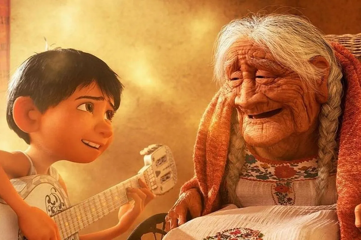 Miguel (12 year old Mexican boy) plays guitar for his smiling grandmother, Coco (elderly Mexican woman) in a scene from the Pixar film, 'Coco.'