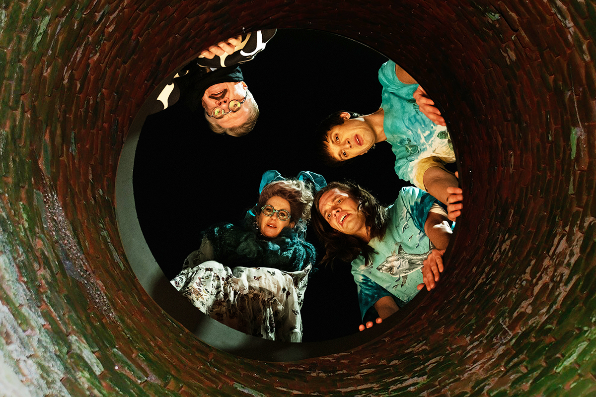 The cast of Dicks the musical looking into a sewer
