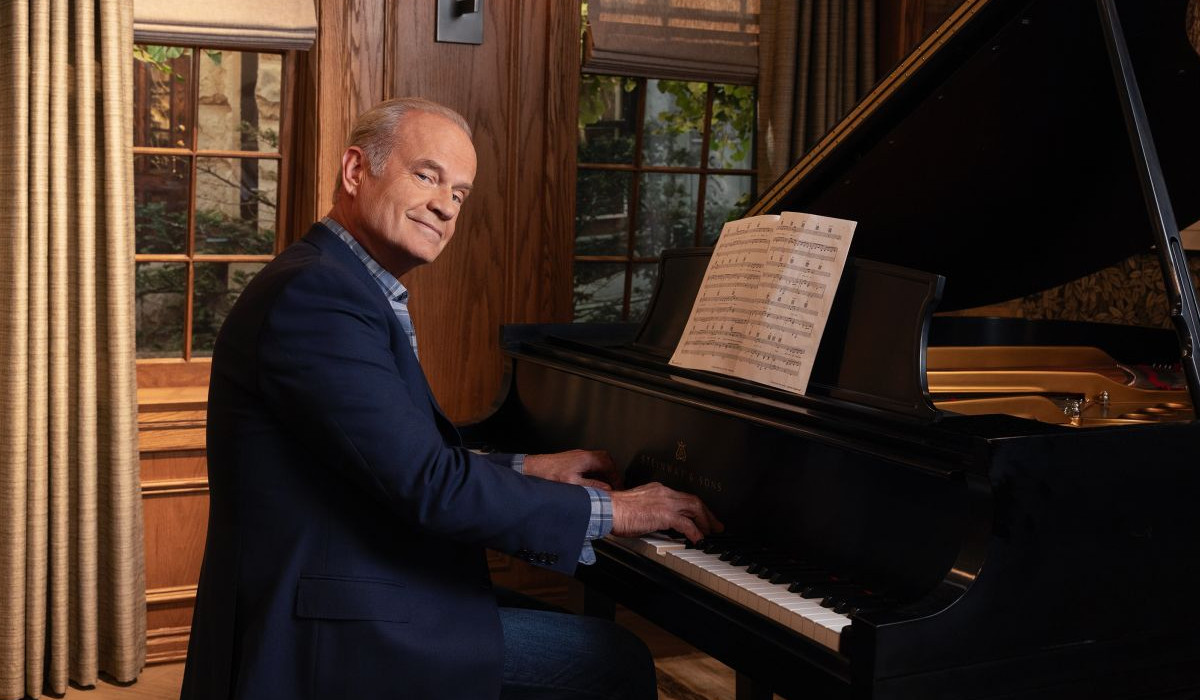 Kelsey Grammer as Frasier Crane sitting behind a piano in the Frasier reboot