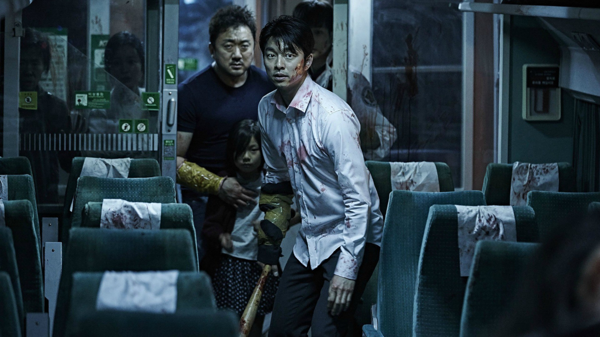 two people covered in blood on a train in 'Train to Busan' 