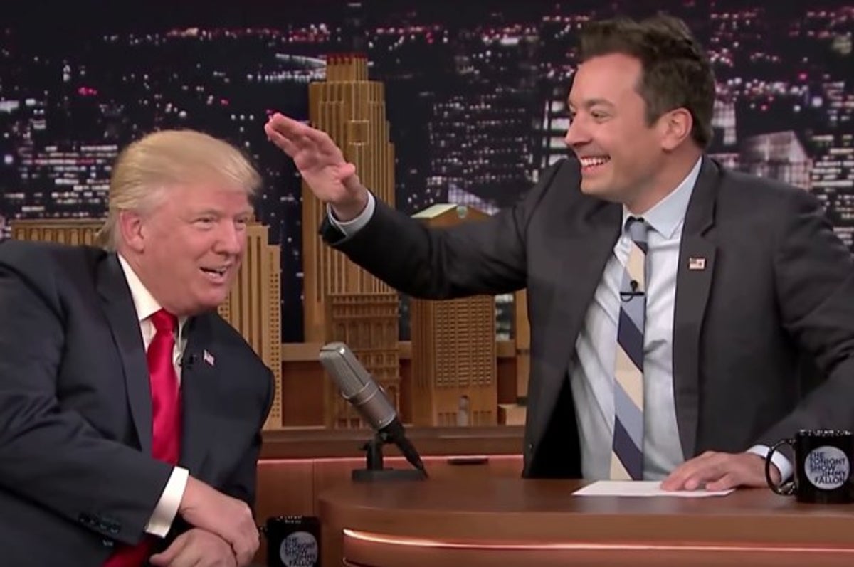 Jimmy Fallon pats Donald Trump's head on The Tonight Show.