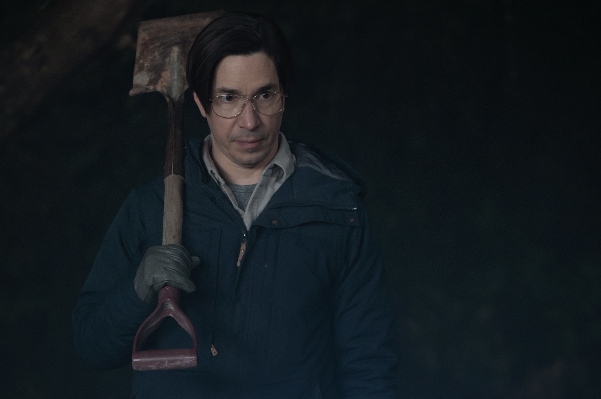 Justin Long holds a shovel and looks concerned in the new 'Goosebumps' series