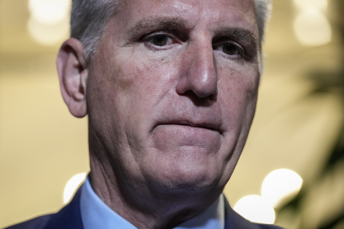 An extreme close-up of Kevin McCarthy biting his lip, looking nervous.