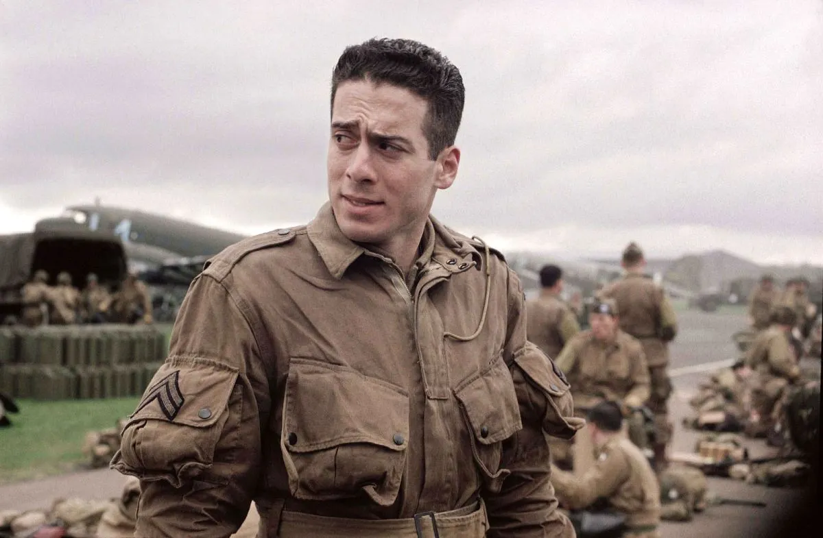A male paratrooper prepares for a jump in 'Band of Brothers'.