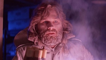 A nearly-frozen, cornered Kurt Russell wards off assailants with a bundle of dynamite in John Carpenter’s ‘The Thing.’