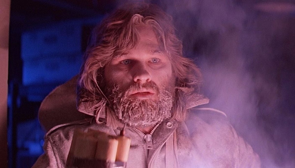 A nearly-frozen, cornered Kurt Russell wards off assailants with a bundle of dynamite in John Carpenter’s ‘The Thing.’