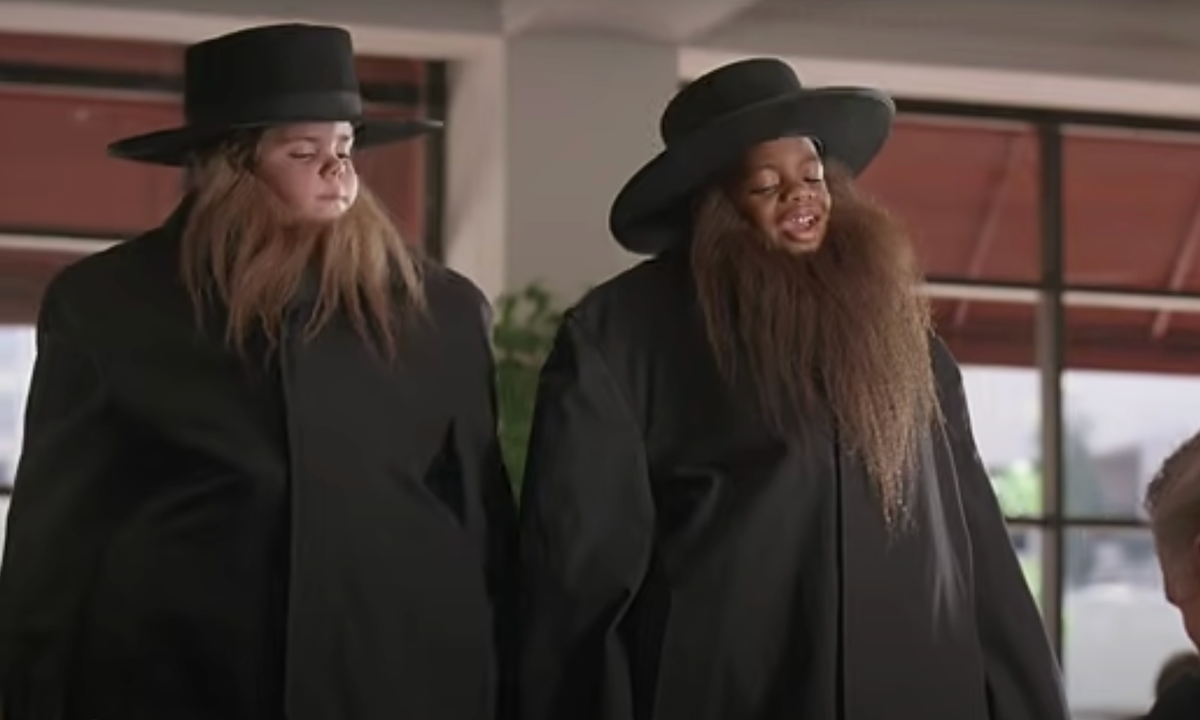 Two of the kids from 'The Little Rascals' in trenchcoats, hats, and beards, pretending to be adults