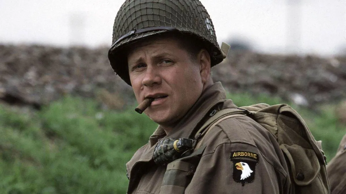 A World War II soldier smokes a cigar in the field in 'Band of Brothers.'