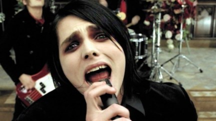 A man with dark eye makeup looks sad while singing in My Chemical Romance's 'Helena' music video.