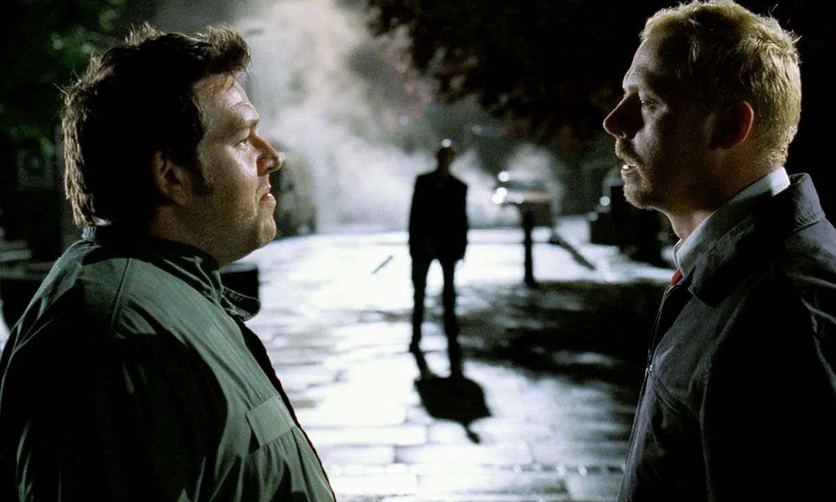 A drunken Ed (Nick Frost) and Shaun (Simon Pegg) skeptically watch a zombie approach them in ‘Shaun of the Dead.’ 