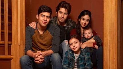 Image of the young cast of Freeform's 'Party of Five' reboot. They are all Latine. Two boys, two girls, and a baby. All of them have dark hair and brown skin. They're sitting on the stairs in a house.