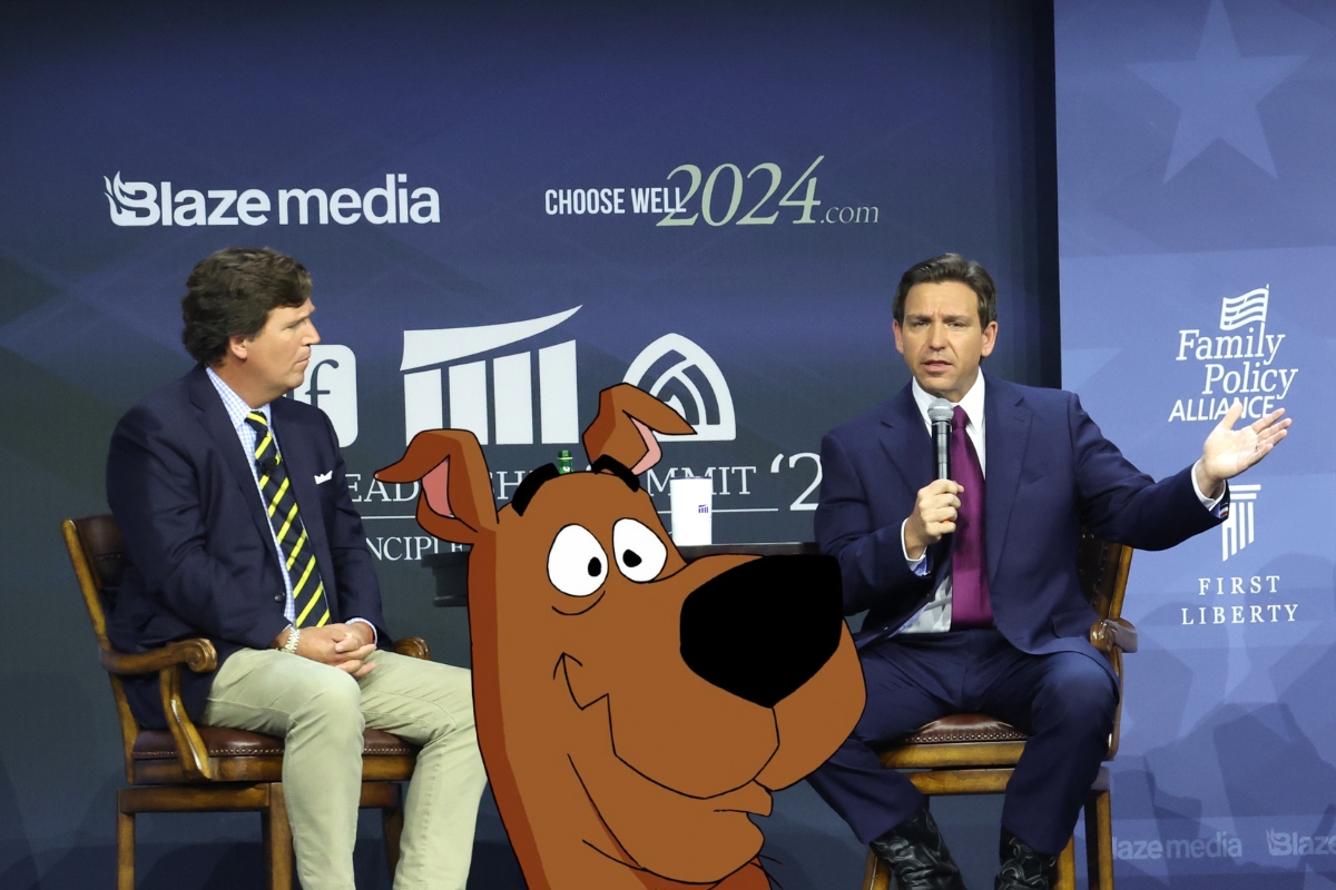 Ron DeSantis and Tucker Carlson speaking at an event. The cartoon dog Scooby-Doo is edited into the photo.