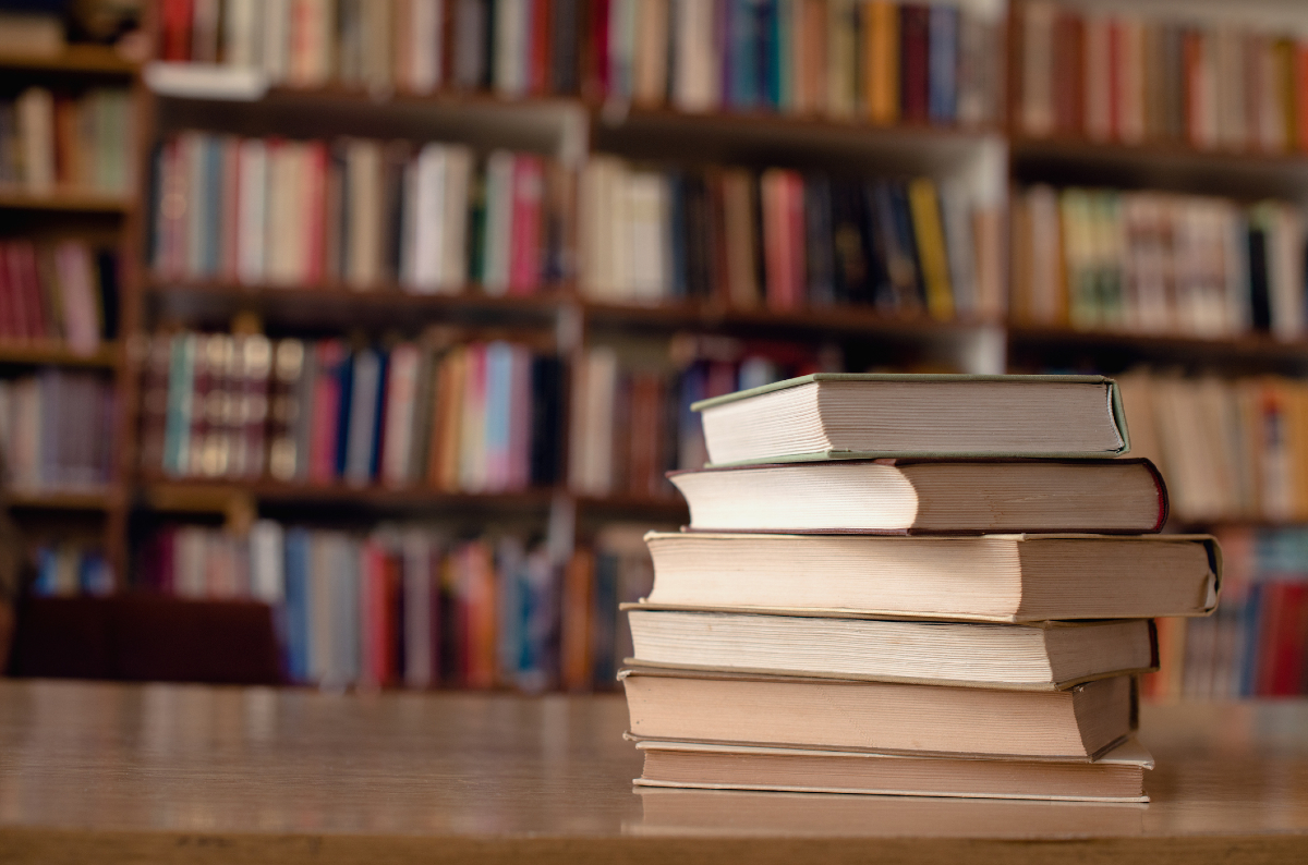 A stack of books on a table in a school library.