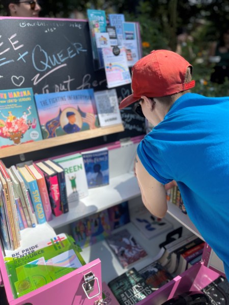 The Nonbinarian Book Bike founder K Kerimian organizes the display at a book drive