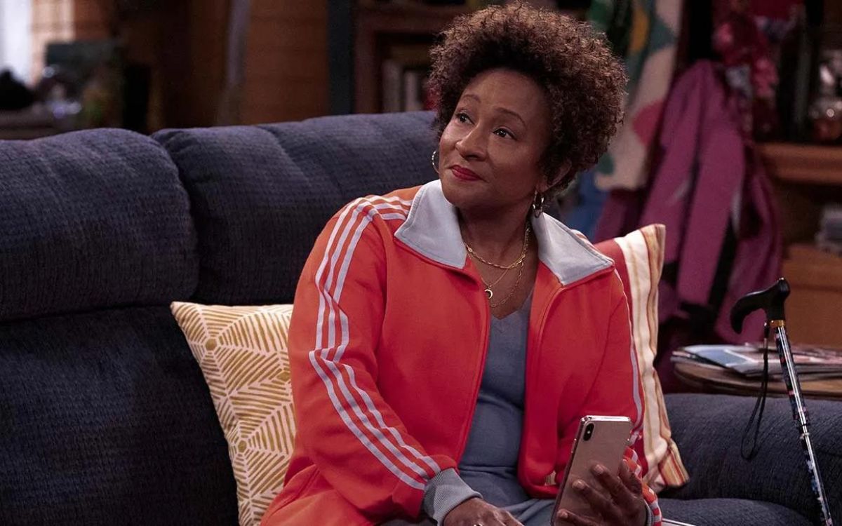 A Black woman with her phone in her hand and a confused look on her face in 'The Upshaws'