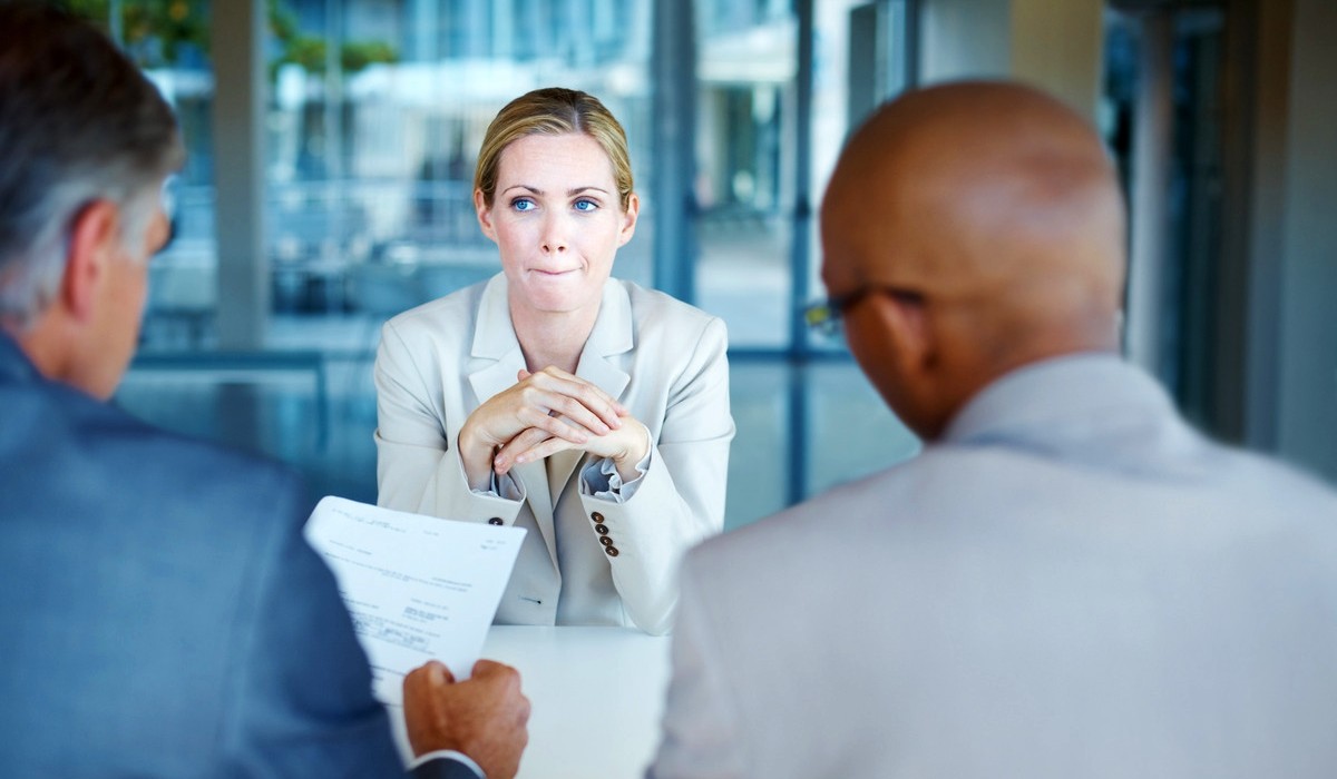 A woman looks unhappy in a job interview