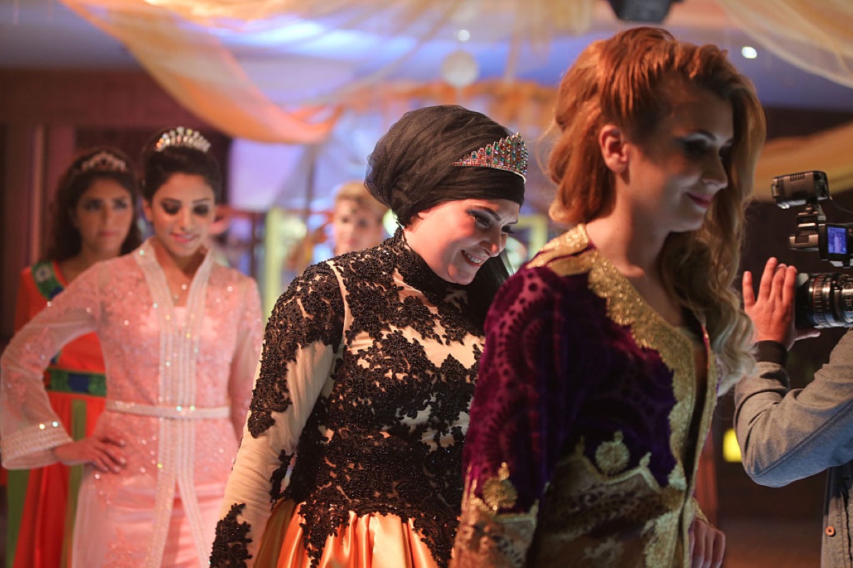 Models displays pieces designed by Jordanian designer Ayat Alzouby (C) in her annual Abaya fashion show in Amman, Jordan, March 20, 2015.