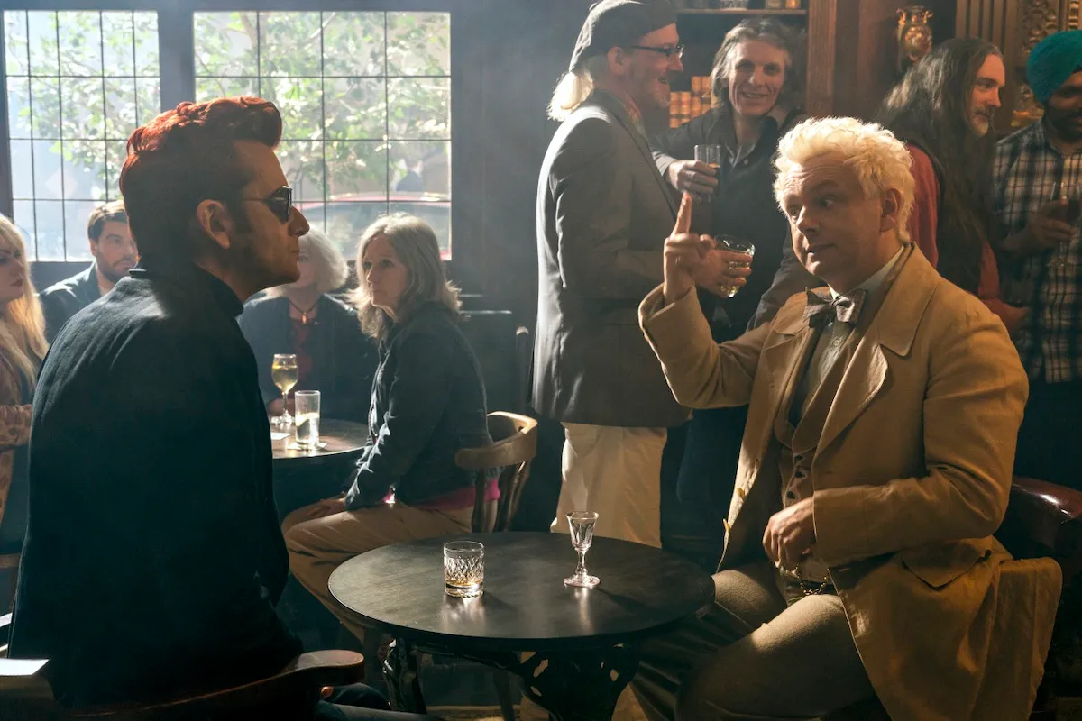 Michael Sheen as Aziraphale and David Tennant as Crowley sit in a pub in 'Good Omens' season 2