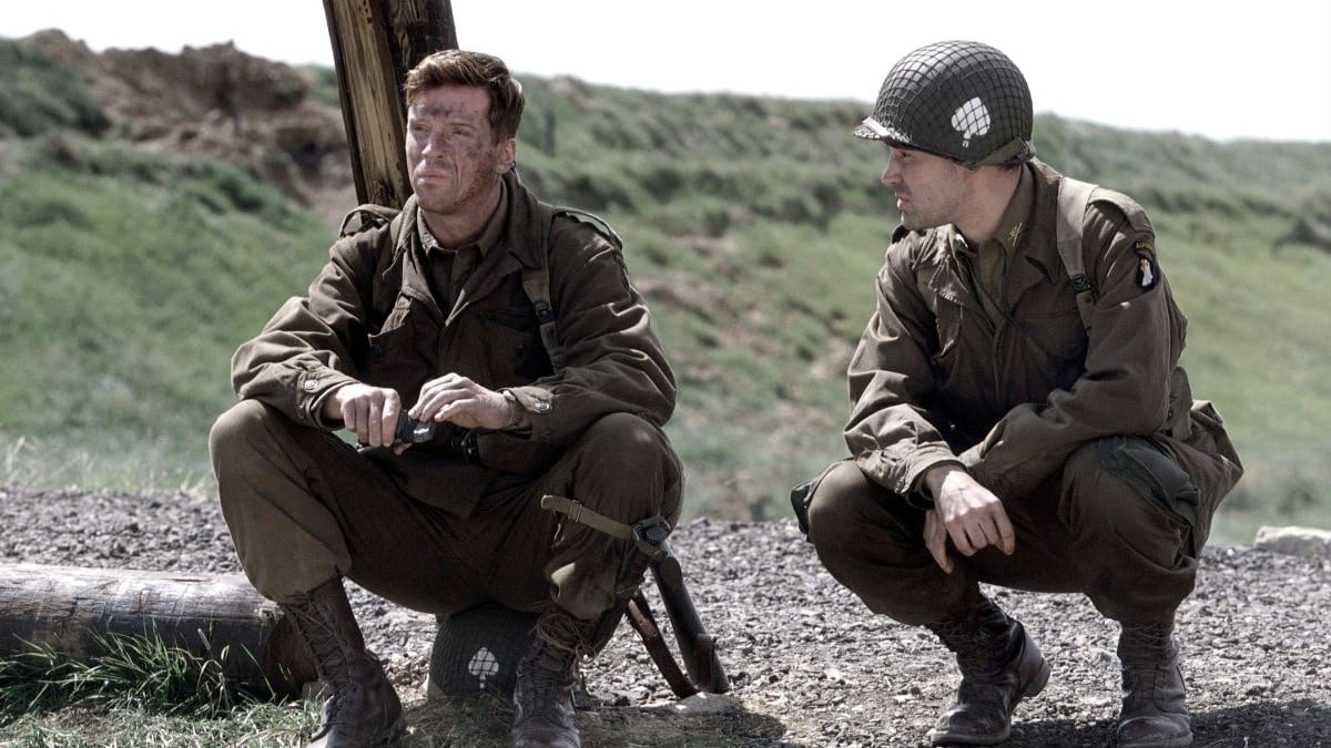 Two soldiers squatting on the ground in 'Band of Brothers'