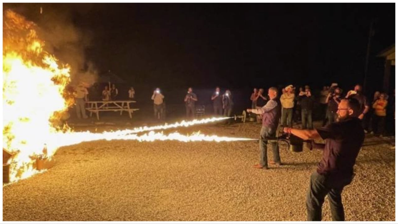 A screenshot of a social media post from Missouri Republican state Sen. Nick Schroer showing Schroer and state Sen. Bill Eigel using flamethrowers on a stack of cardboard boxes.