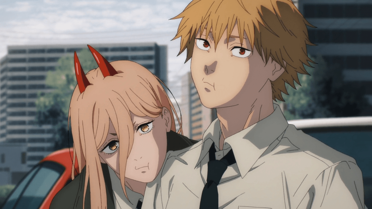 A young man and woman stand in a cityscape leaning on each other while staring that the camera in "Chainsaw Man"